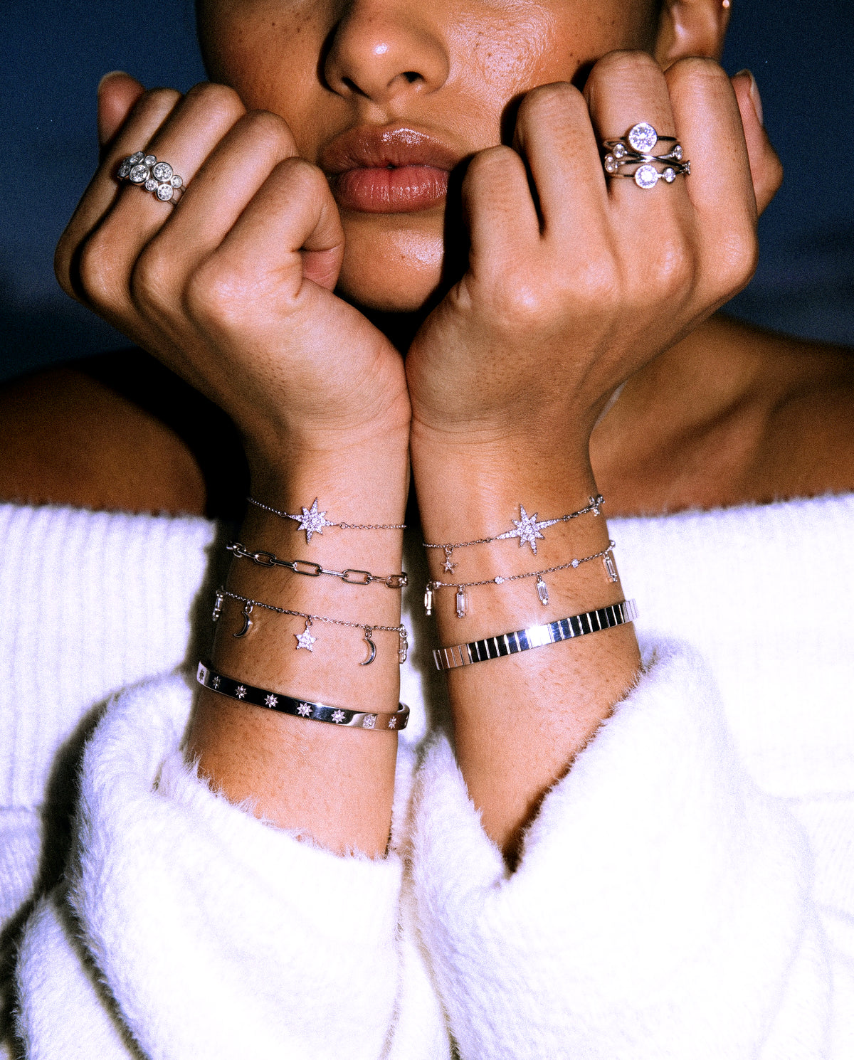 Stacked silver star bracelets, bangles and bubble rings
