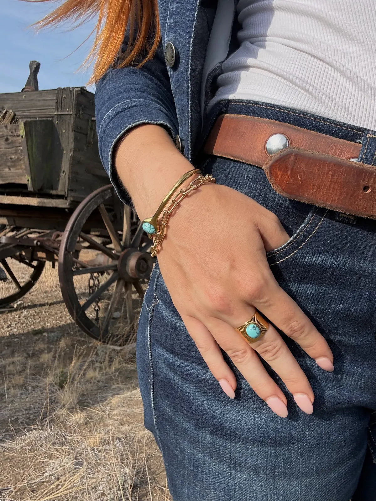 Turquoise cuff bracelet, gold ball link bracelet and turquoise ring with denim and a leather belt