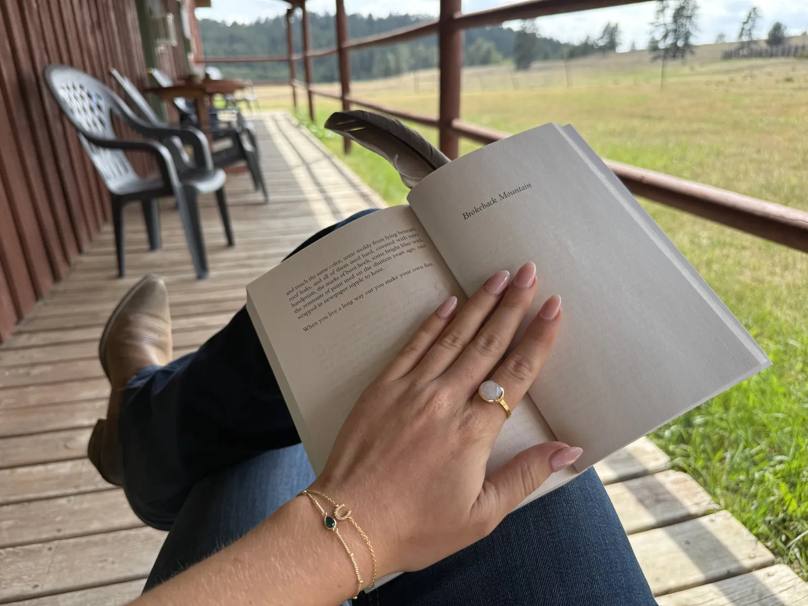 Horseshoe bracelet, moonstone ring and green onyx bracelet on a ranch porch